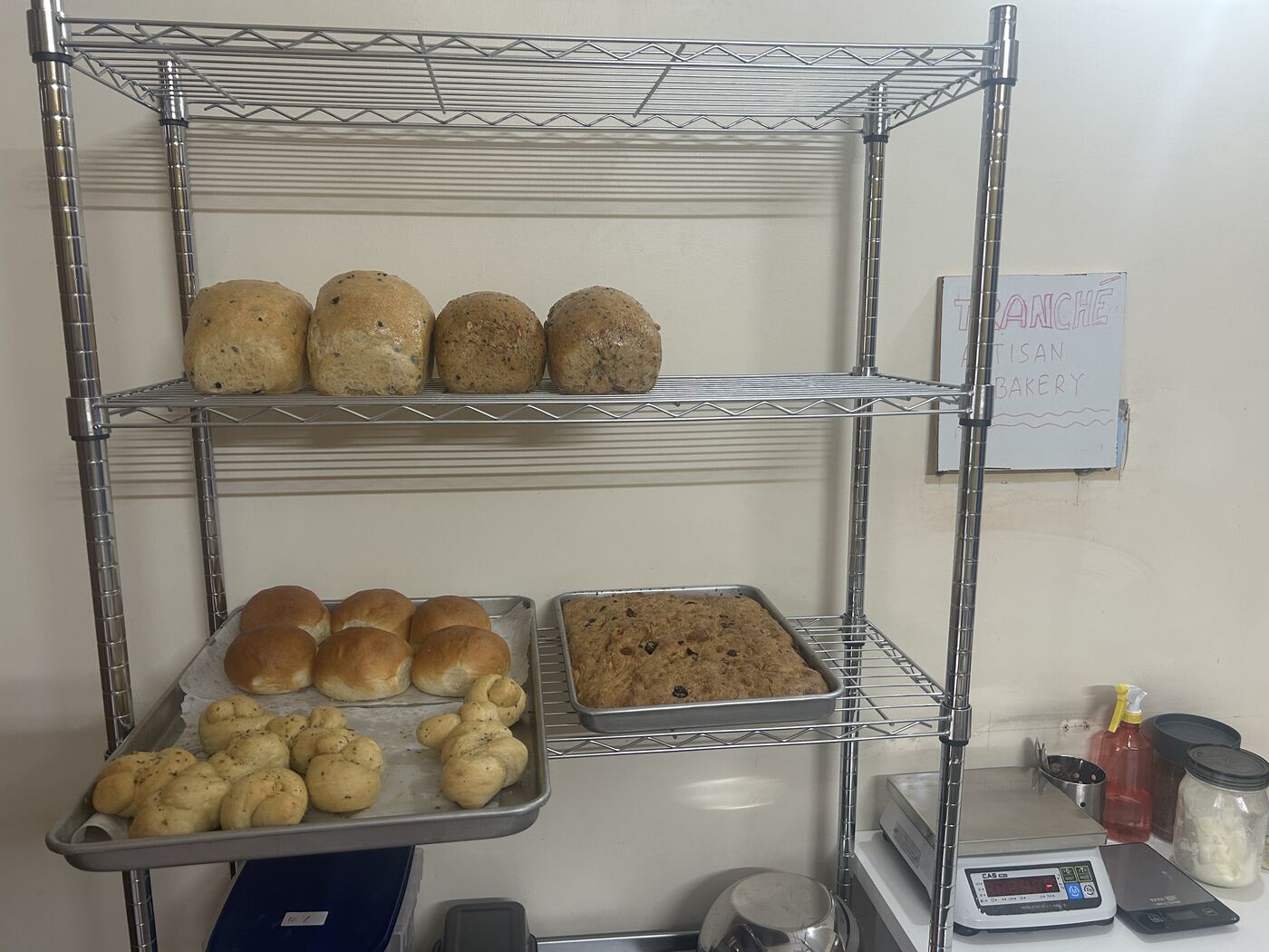 Freshly baked breads cooling on bakery racks